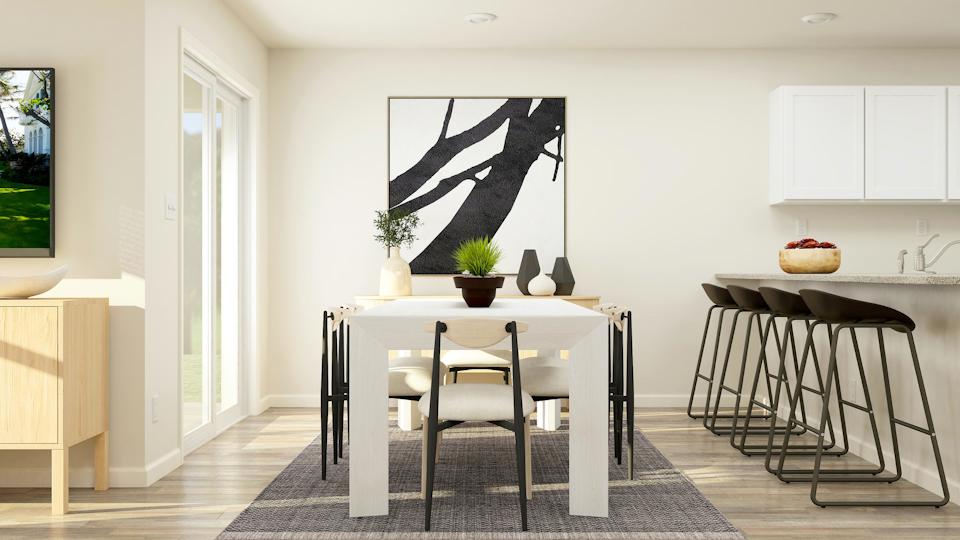 A dining room with a table and chairs.