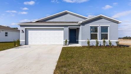 A white house with a driveway.