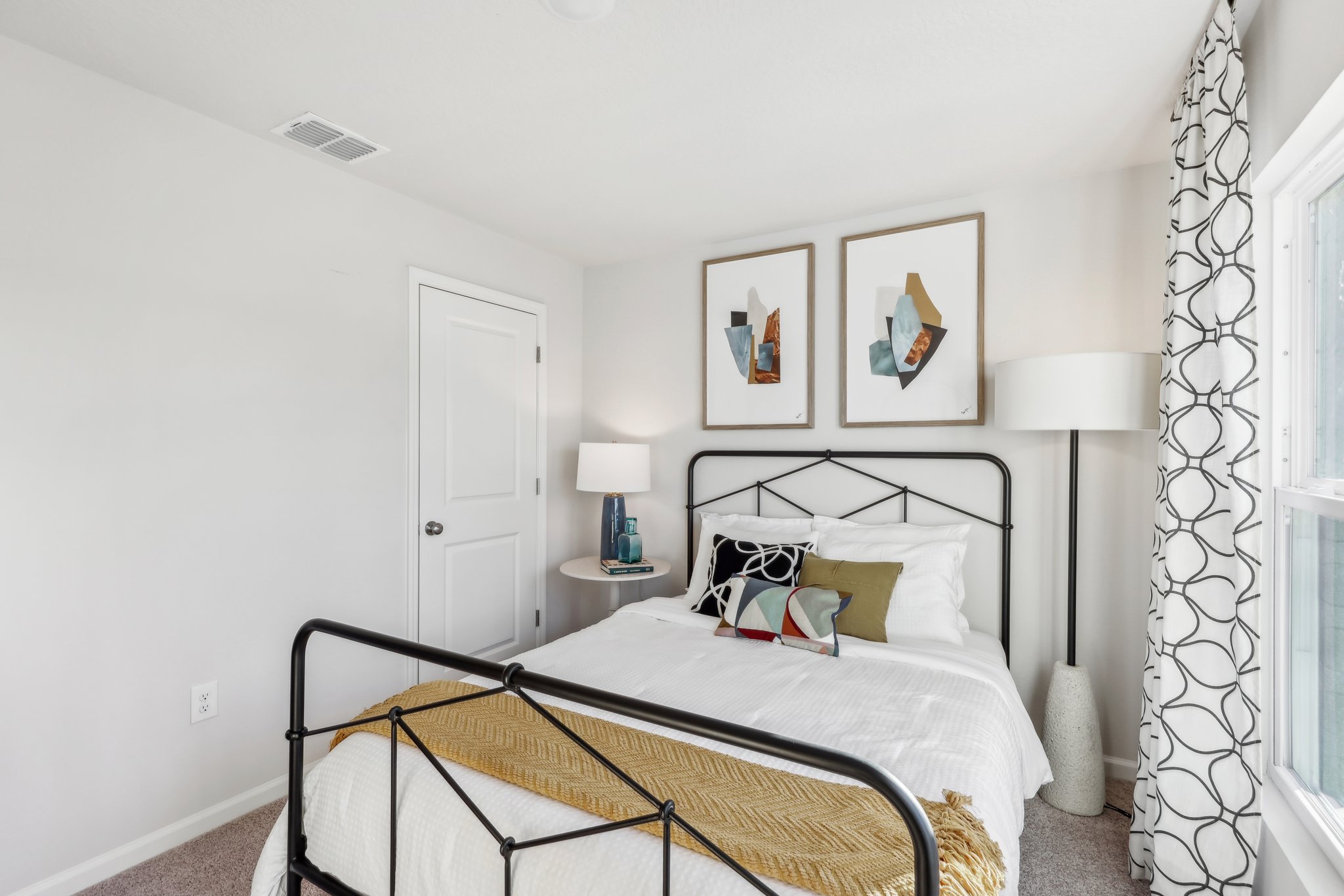 A bed with a black frame.