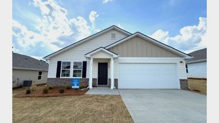 A house with garages and a driveway.