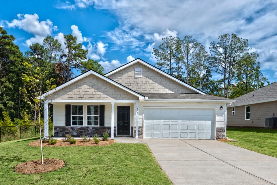 A house with a garage with Little White House in the background.