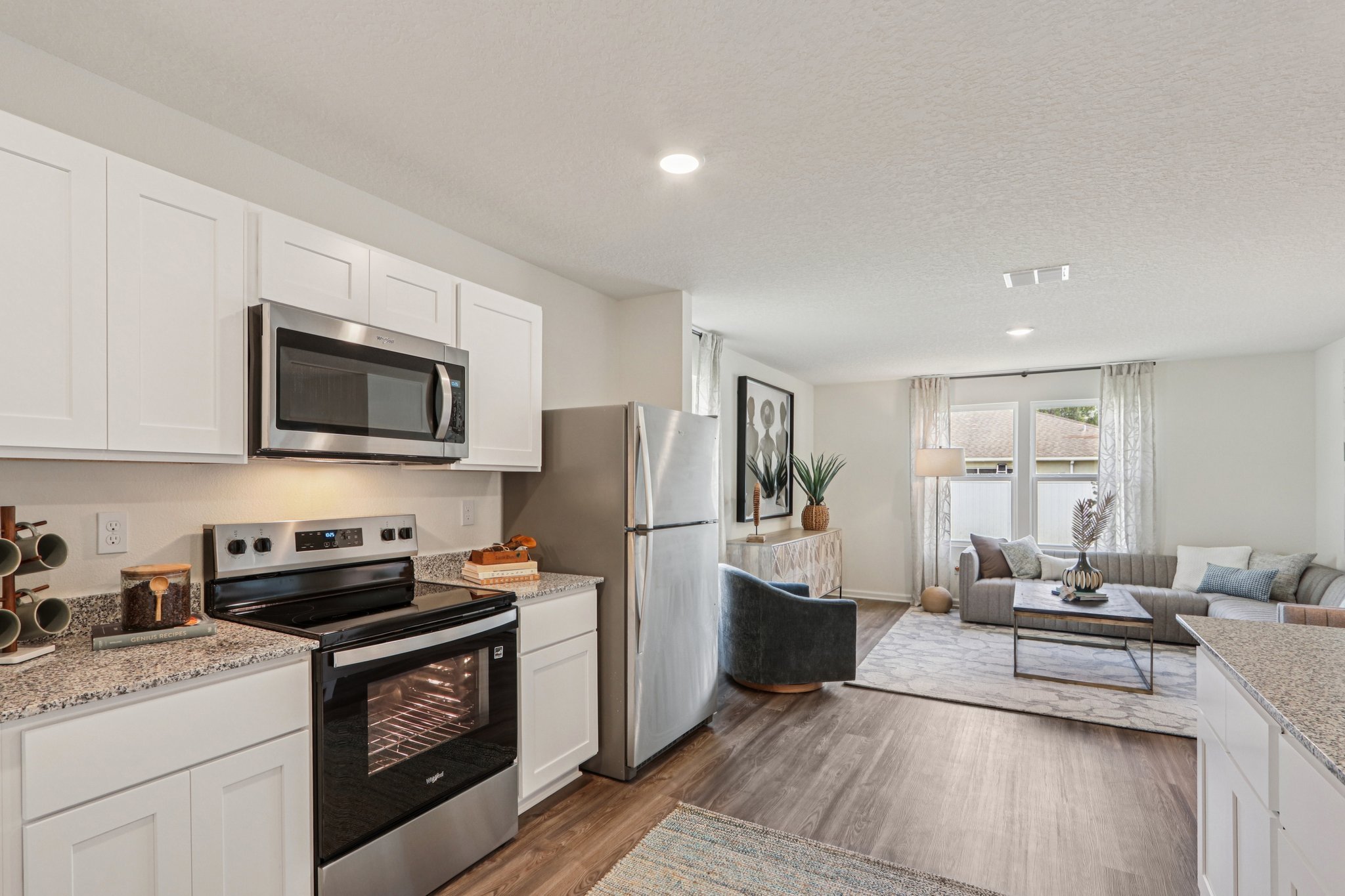 A kitchen with white cabinets.
