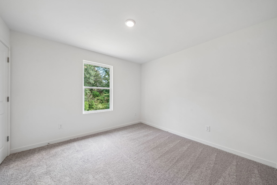A room with a window and a door.