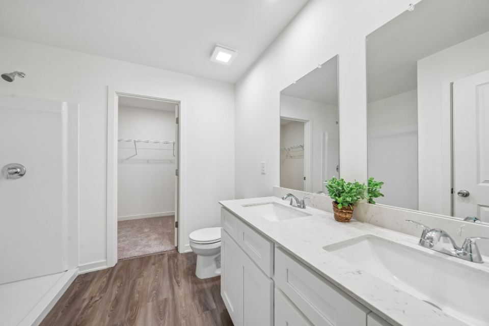 A bathroom with a tub sink and toilet.