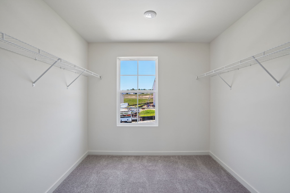 A room with a window and a carpet.