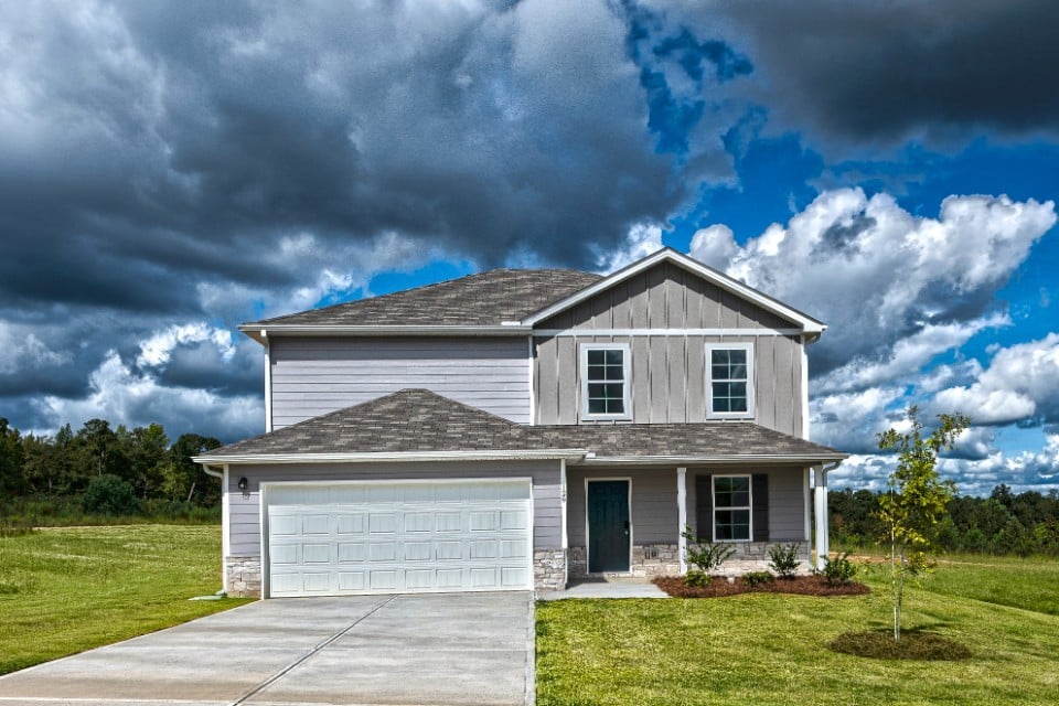 A house with a garage and grass.