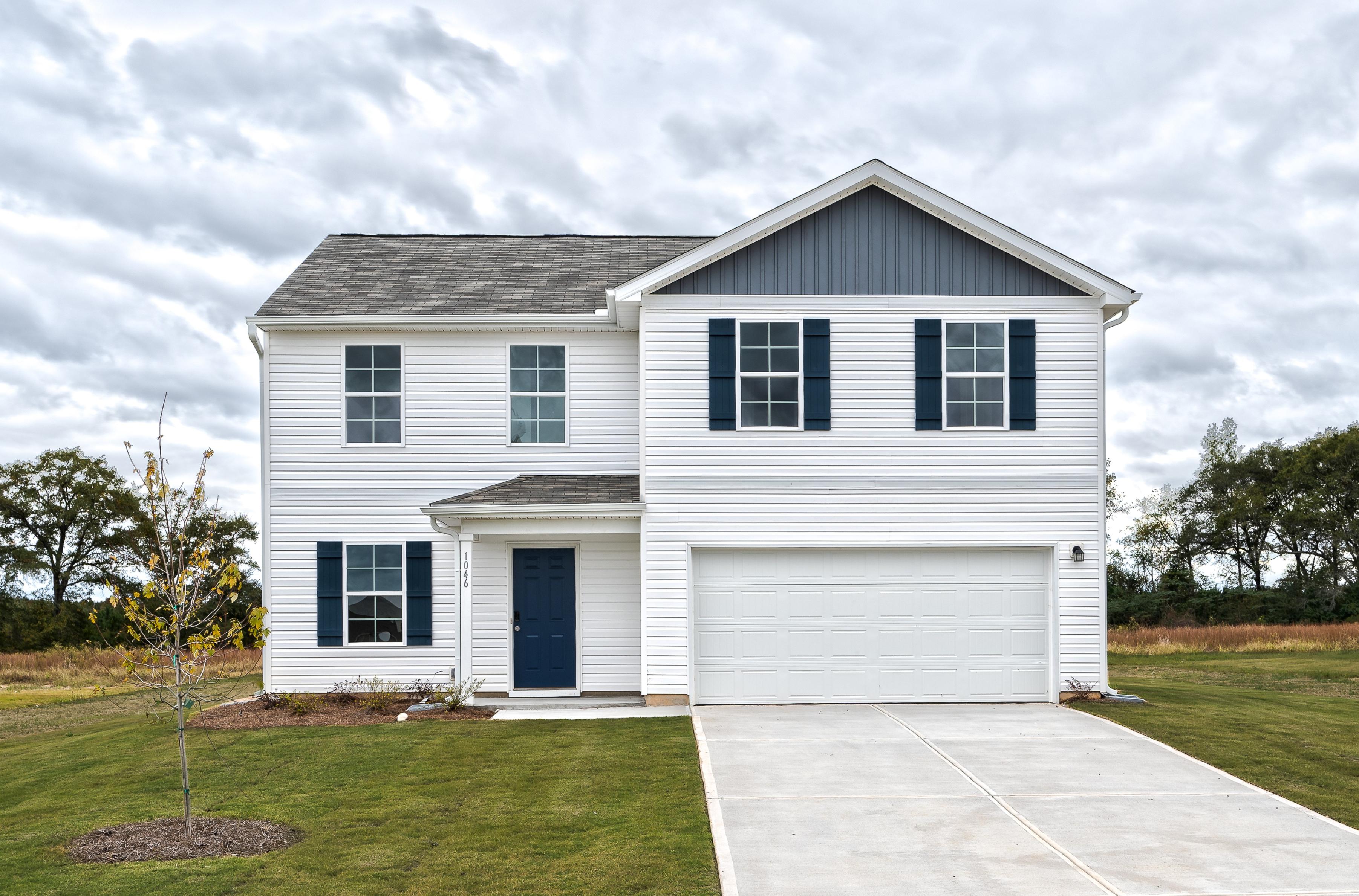 A white house with a garage.