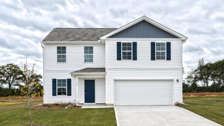 A white house with a garage.