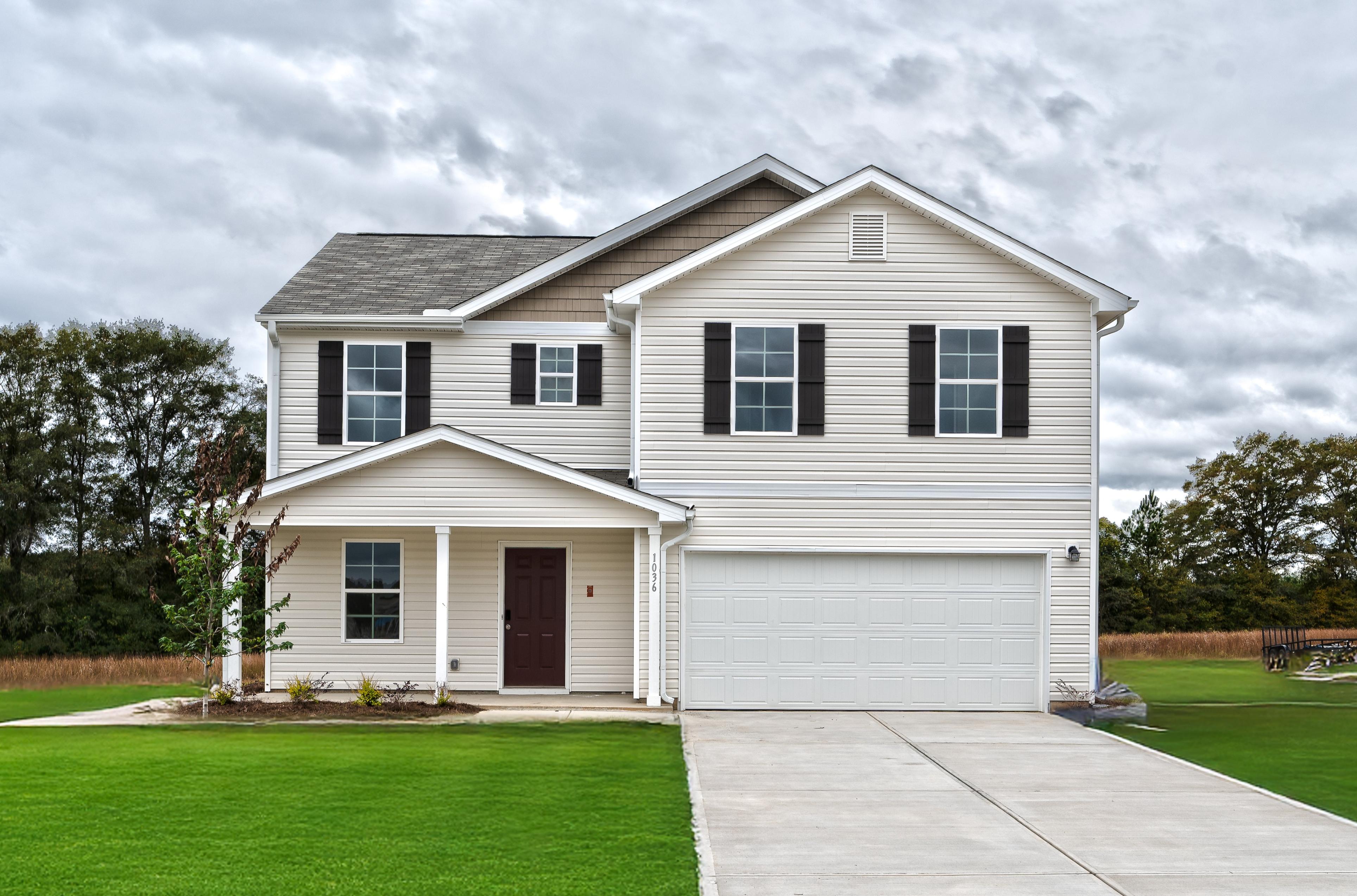A white house with a driveway.