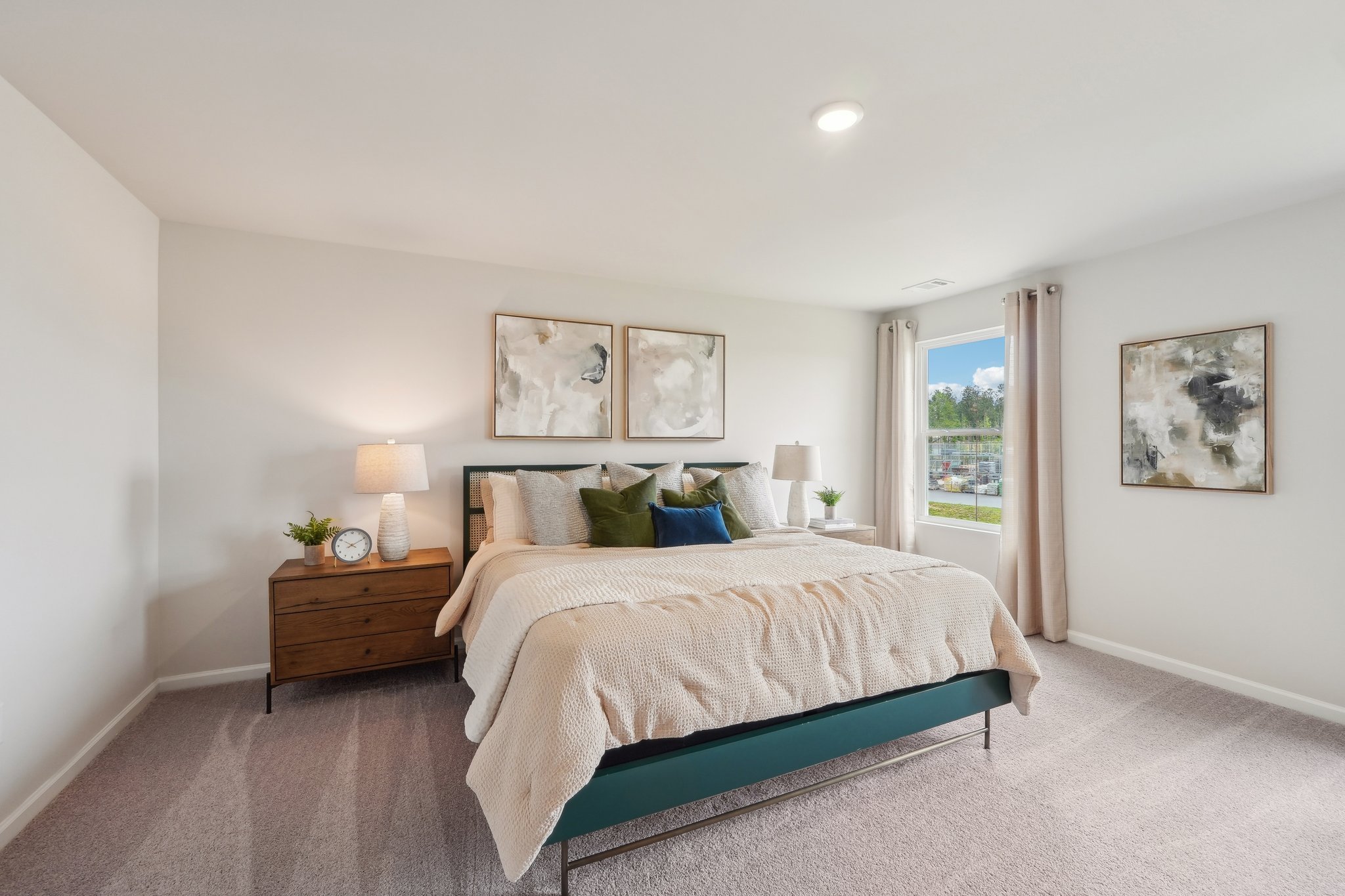 A bedroom with a bed and lamps.