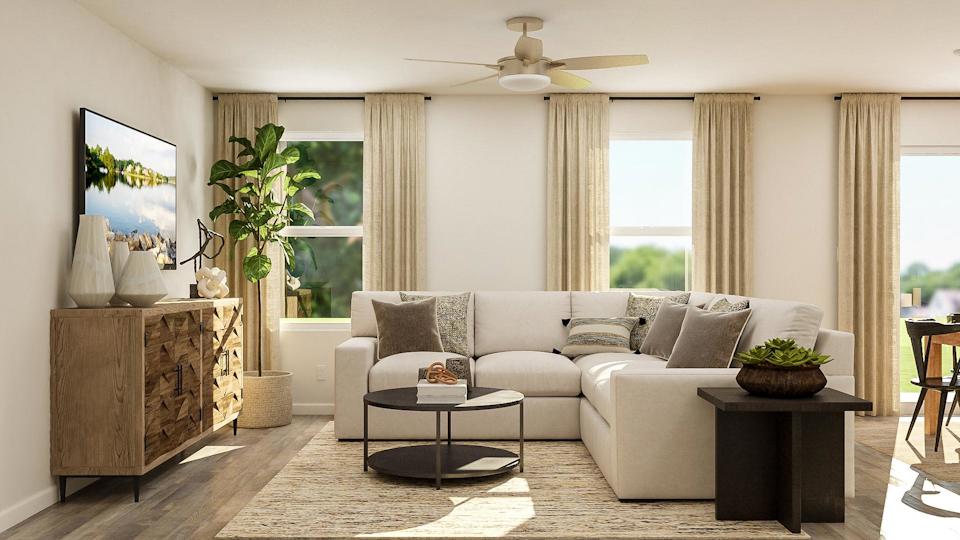 A living room with a white couch and a table.