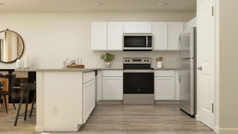 A kitchen with white cabinets.