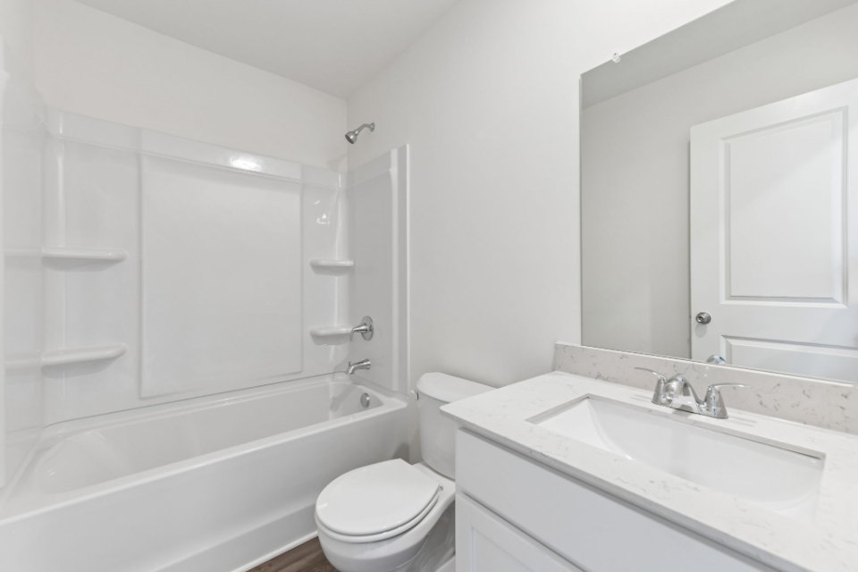 A bathroom with a sink toilet and bathtub.
