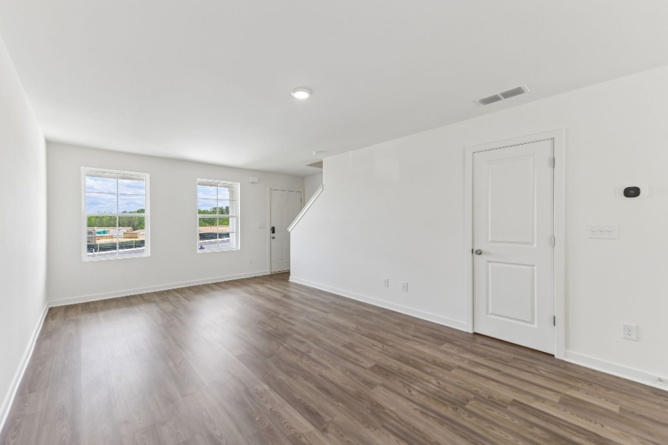 A room with white walls and a wood floor.
