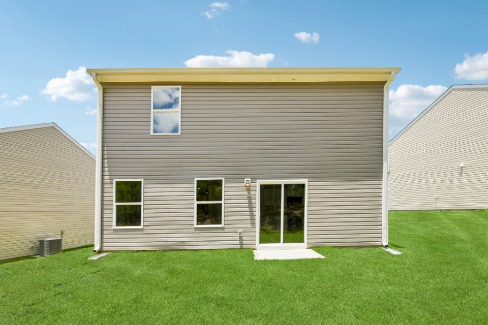 A house with a green lawn.