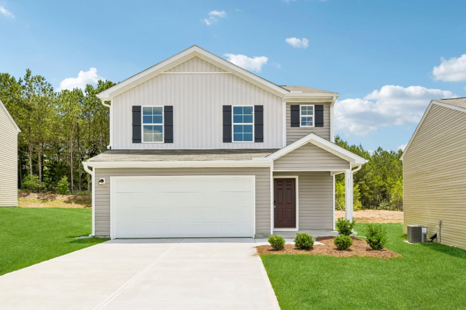 A white house with a garage.
