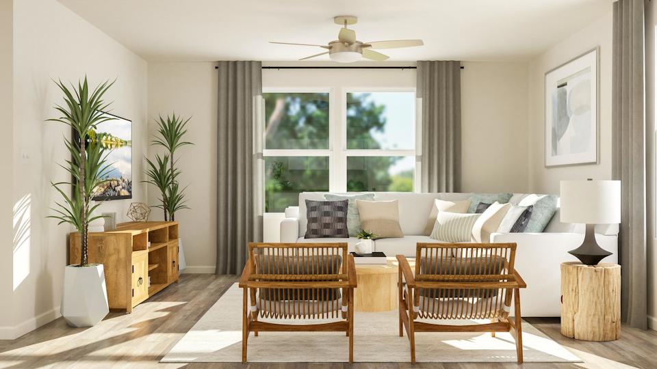 A living room with a white couch and a table.