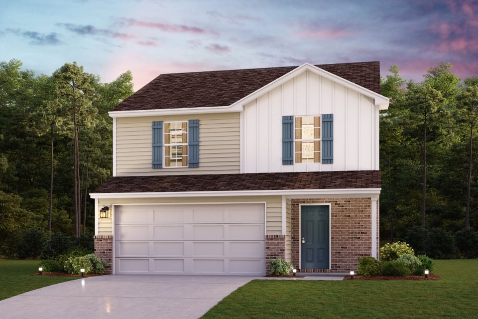 A house with a garage and trees in the back.