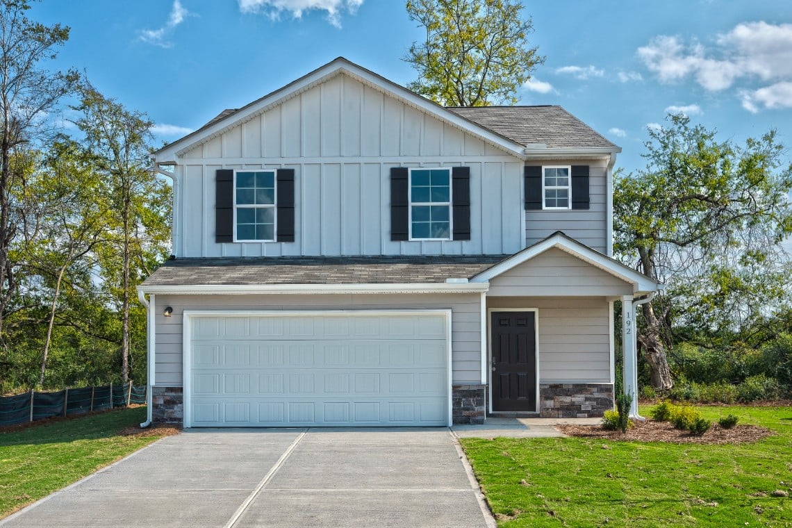 A house with a garage with Ronald Reagan Boyhood Home in the background.