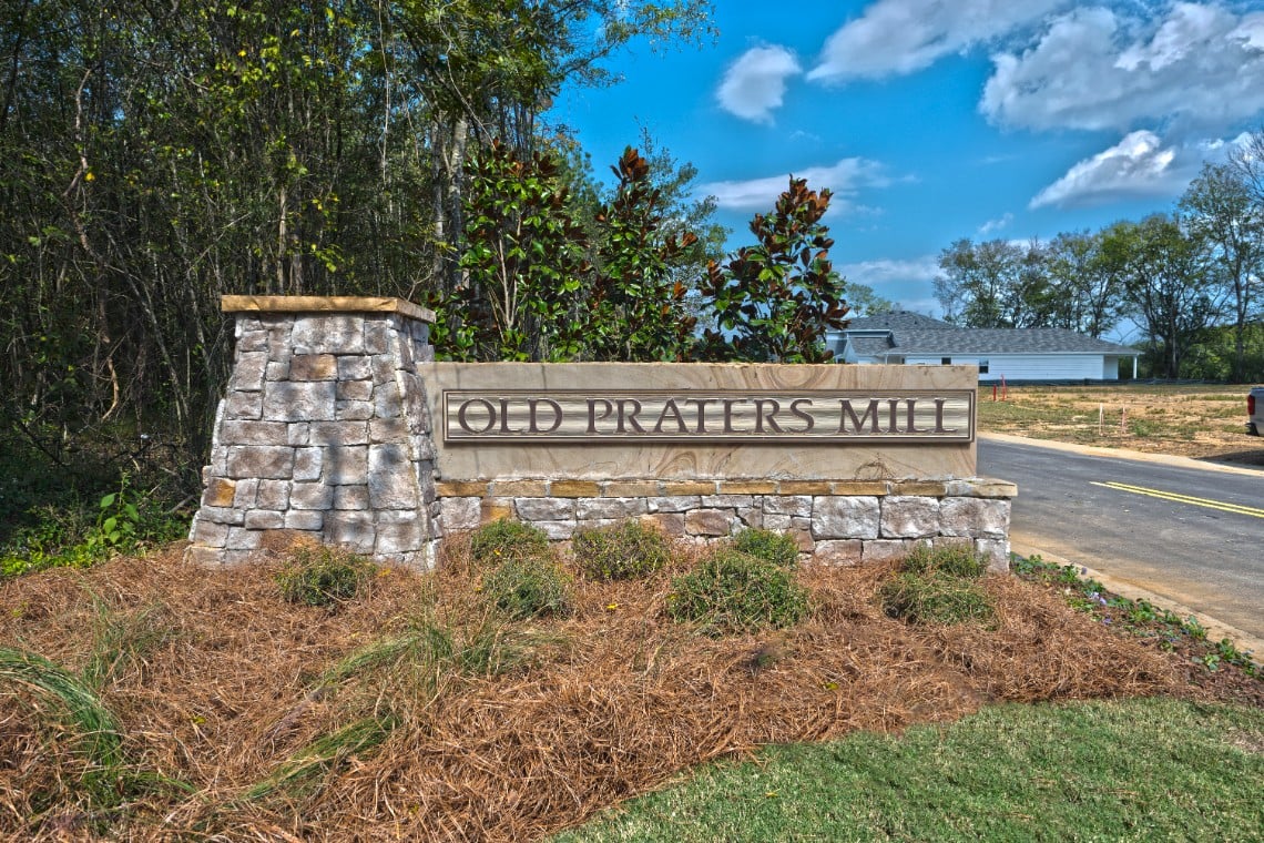A sign on a stone wall.