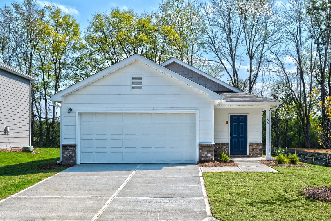 A white garage with a blue door.