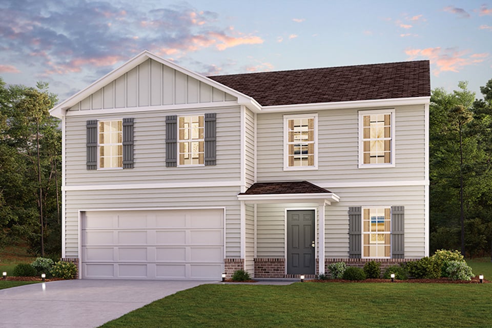 A white house with a garage.