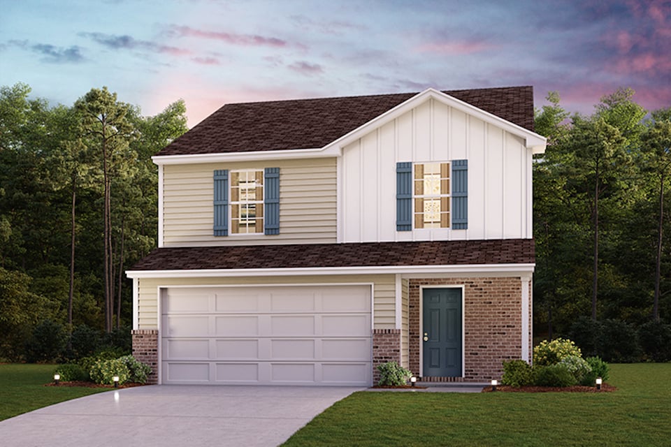 A house with a garage and trees in the back.