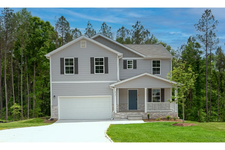 A house with a garage and trees.