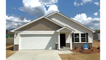 A white house with a garage.