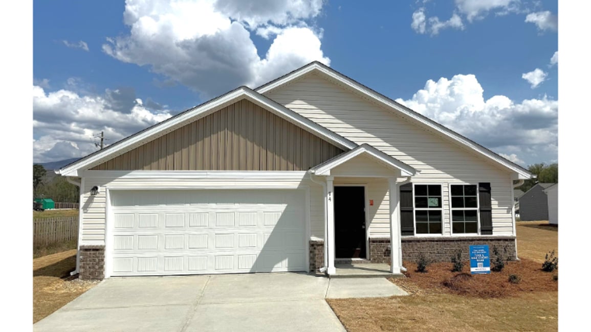 A white house with a garage.