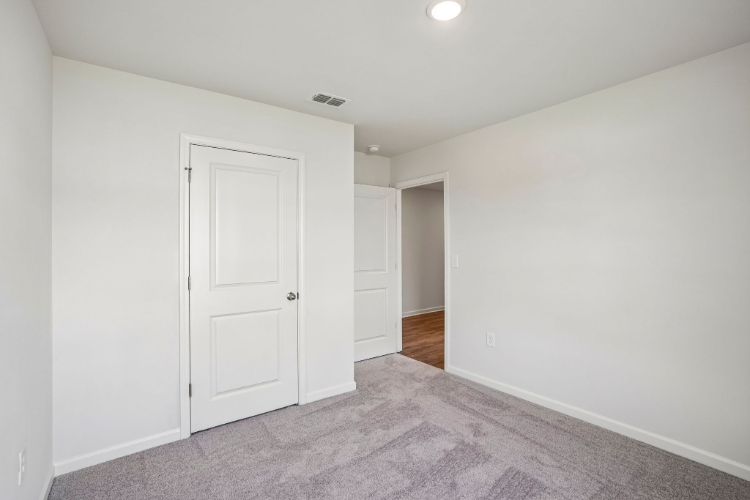 A hallway with white doors.