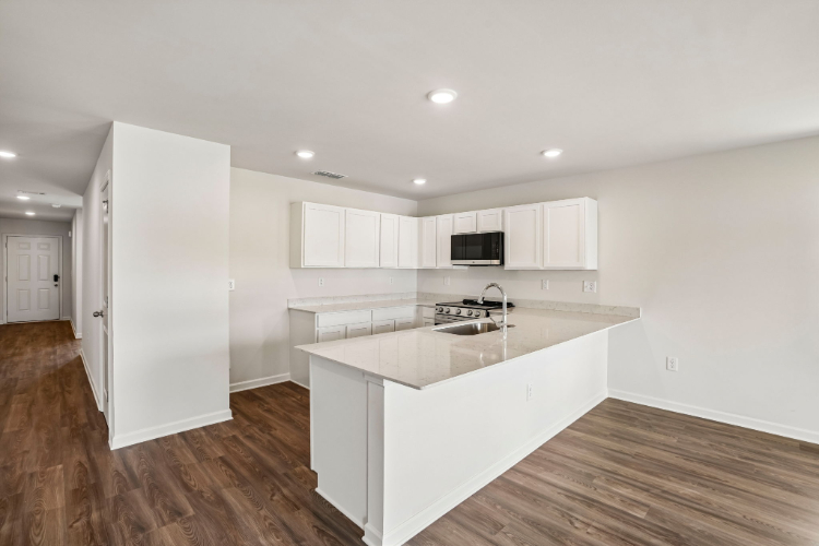 A kitchen with white cabinets.