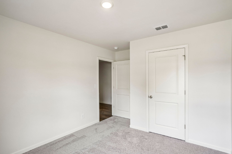 A hallway with white doors.