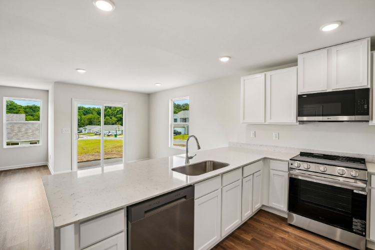 A kitchen with white cabinets.