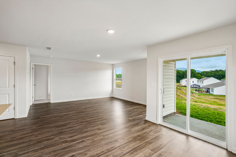 A room with a wood floor and a wood floor with a window.