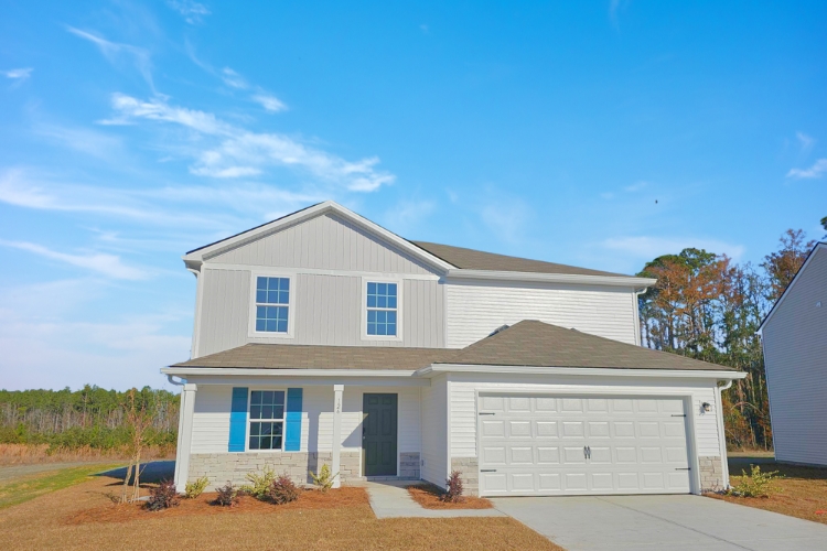 A white house with a garage.