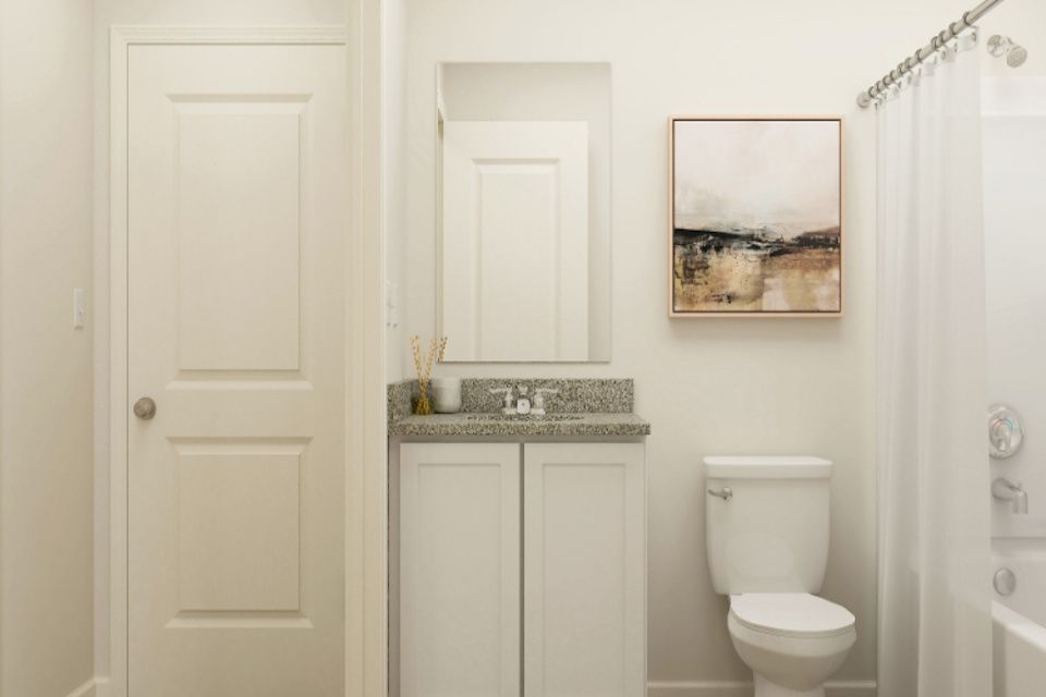 A bathroom with a sink toilet and a shower.