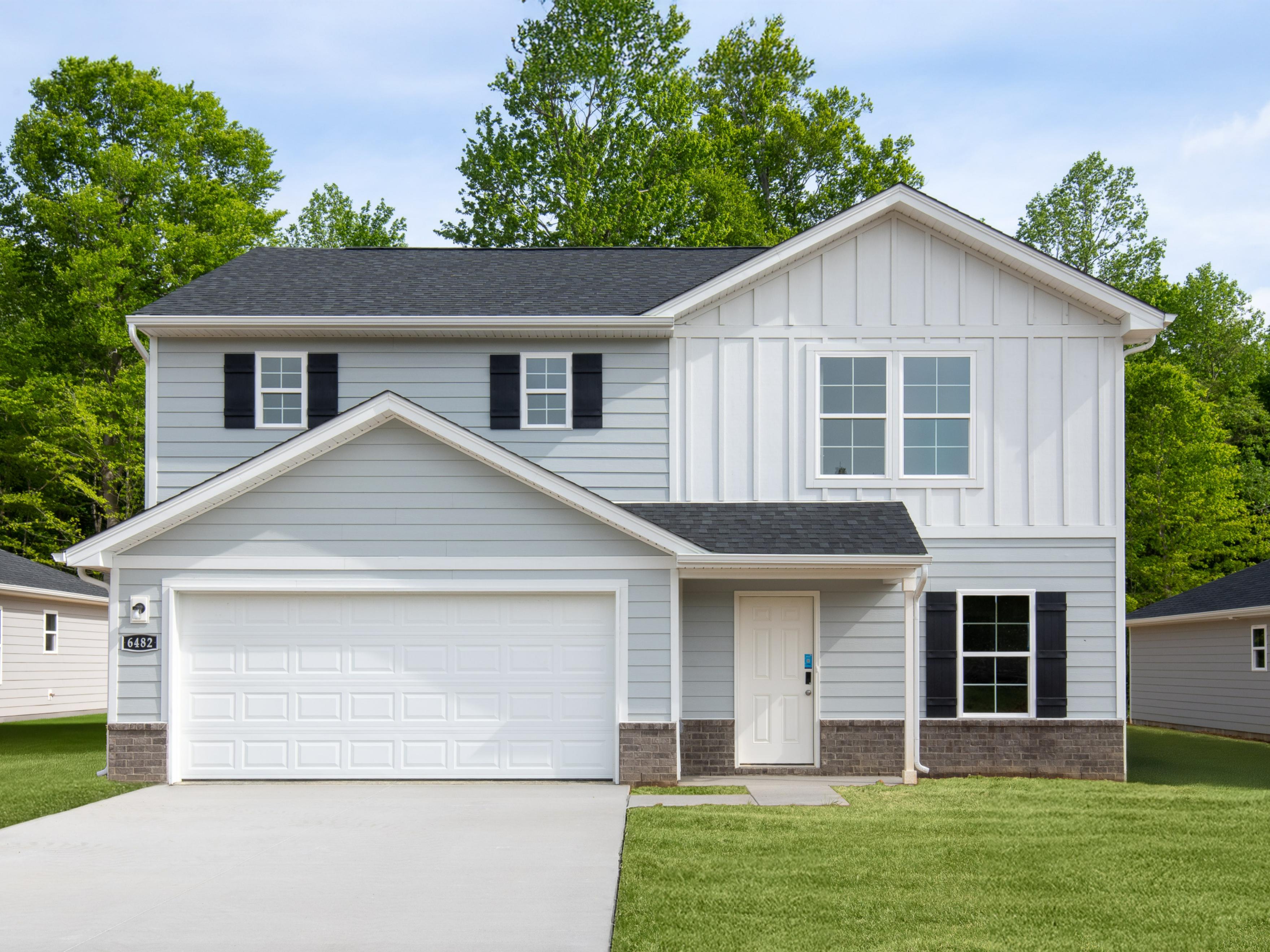 A white house with a garage.