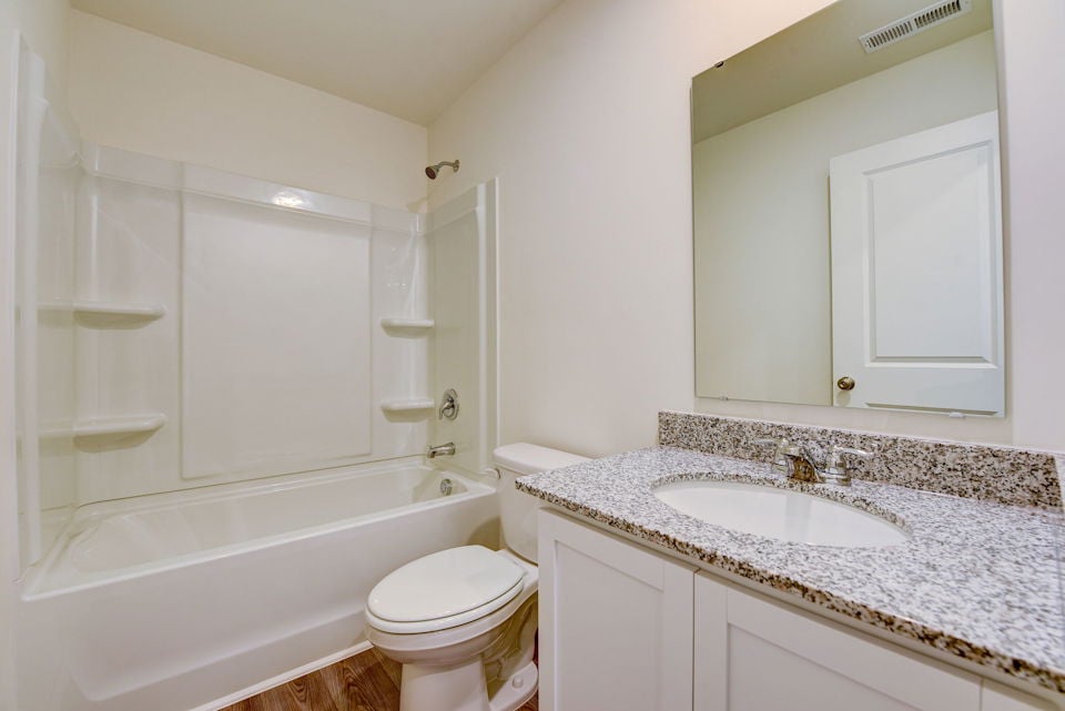 A bathroom with a marble countertop.