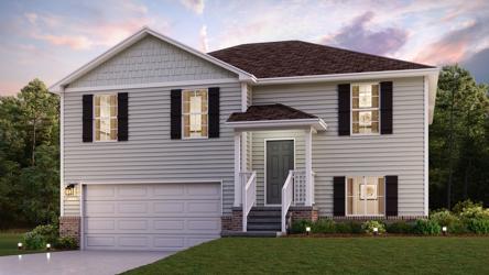 A white house with a green lawn.