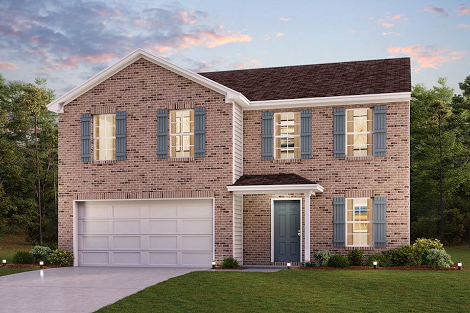 A brick house with a garage.
