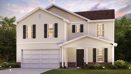 A white house with a lawn.