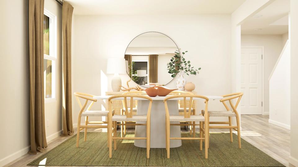 A dining room table with chairs around it.