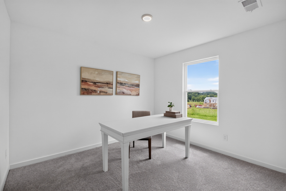A room with a table and a window.