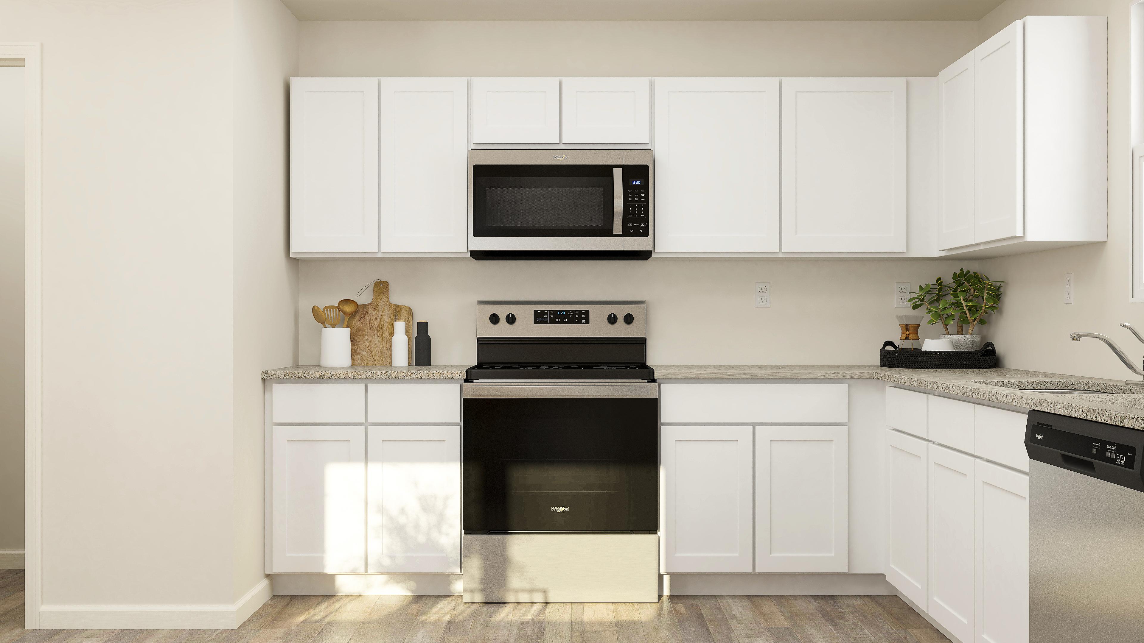 A kitchen with white cabinets.