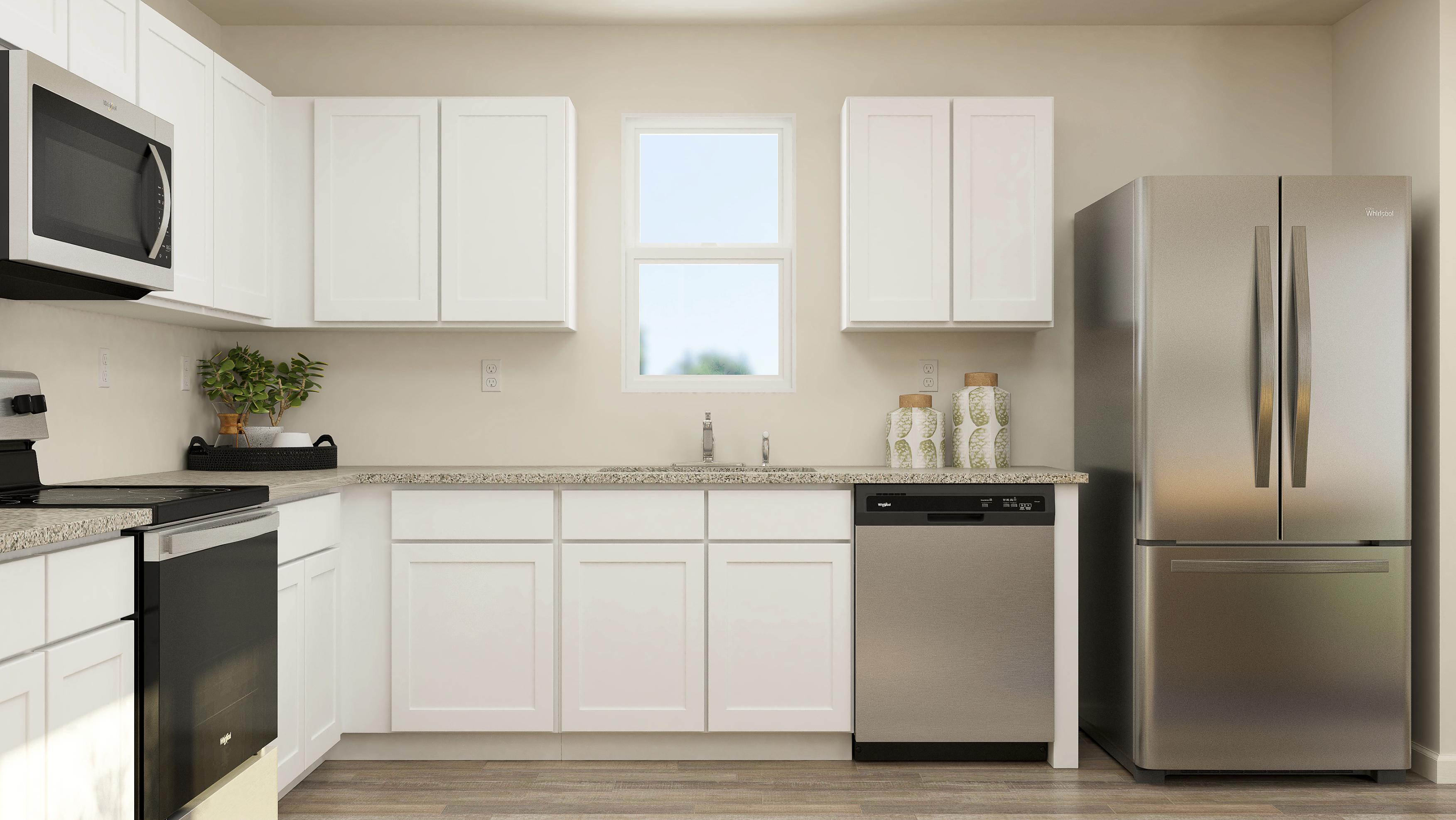 A kitchen with white cabinets.