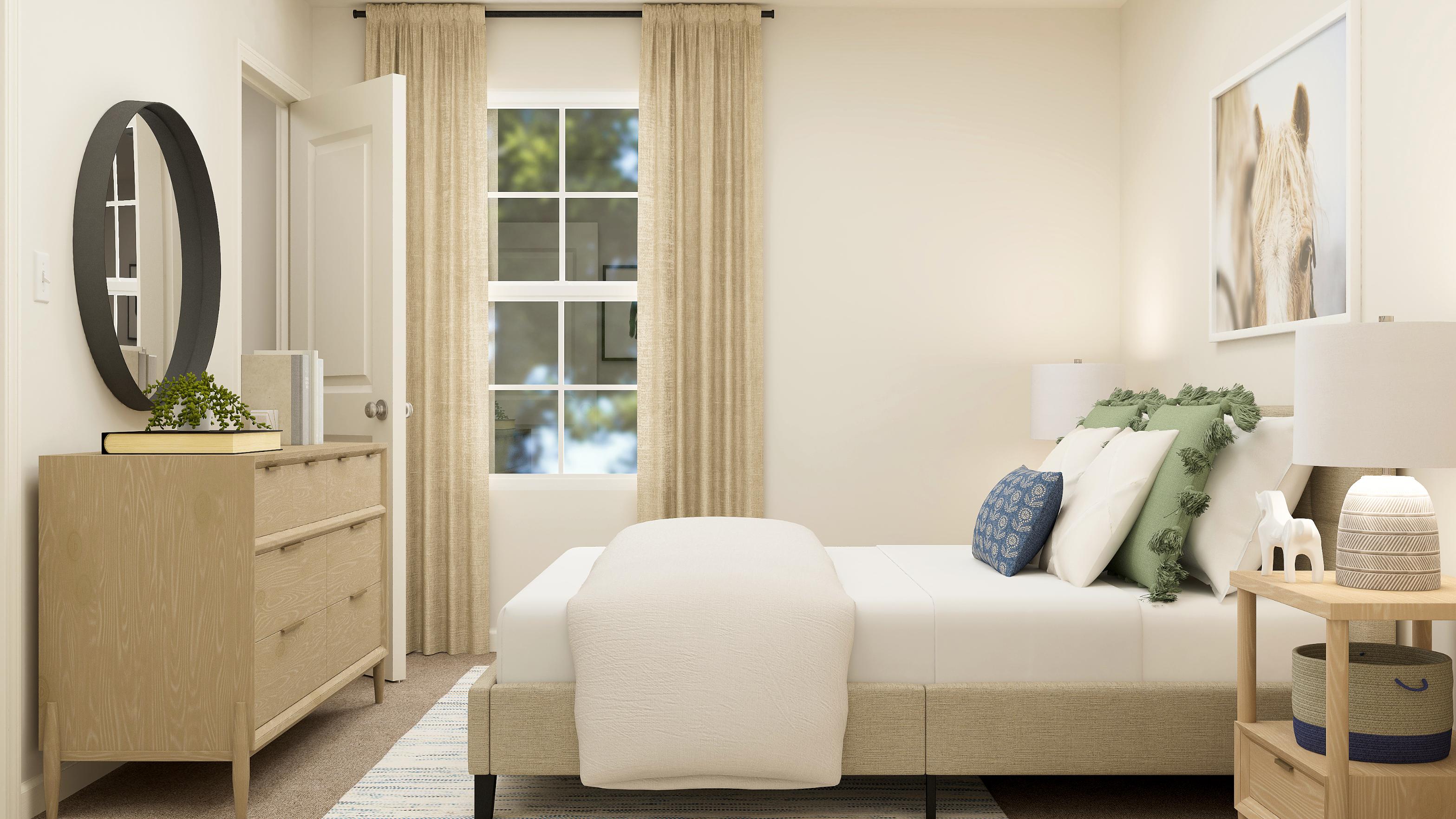 A living room with a white couch and a white chair.