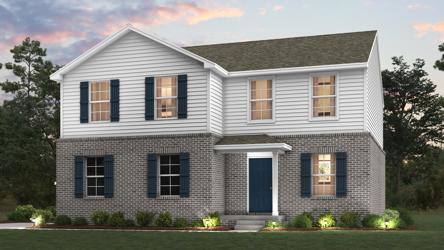 A house with a lawn in front of it.