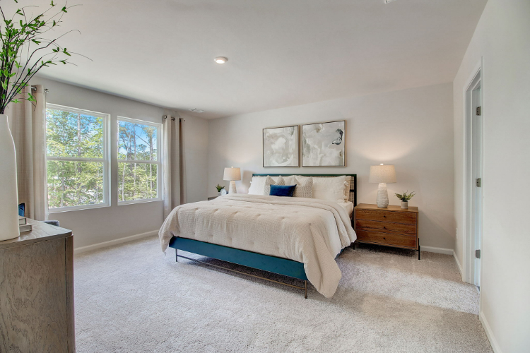 A bedroom with a bed and a window.