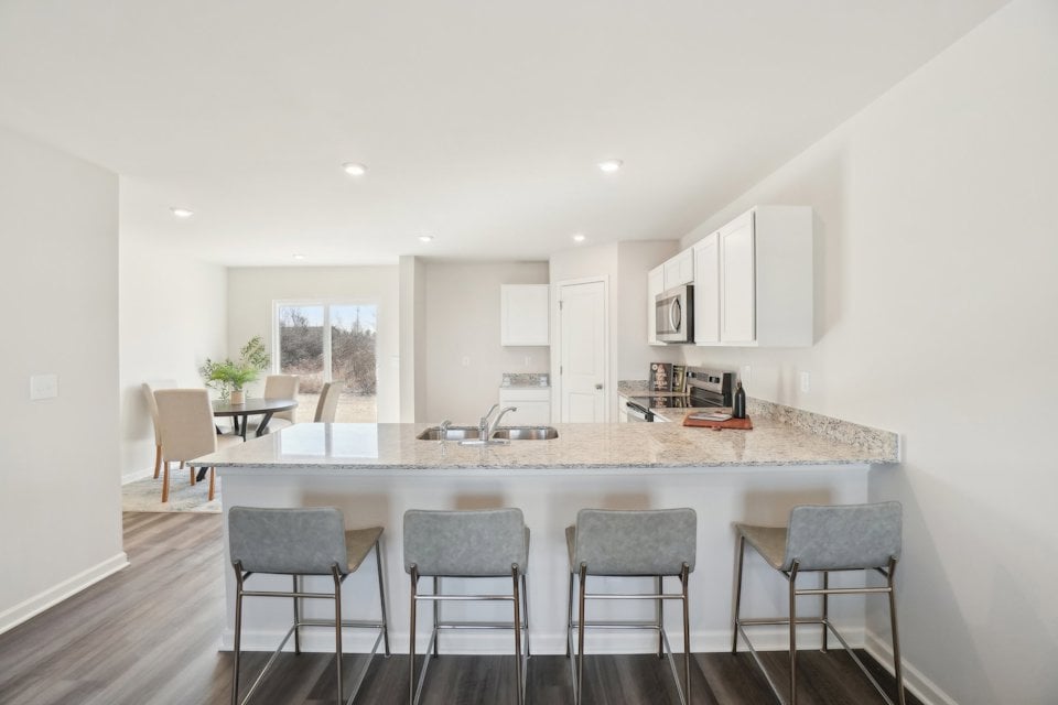 A kitchen with a marble island.